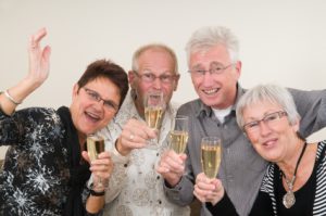 Two senior couples toasting on a Happy New Year.